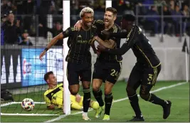  ?? PHOTO BY RAUL ROMERO JR. ?? LAFC’S Timothy Tillman, left, celebrates with Ryan Hollingshe­ad, middle, and Jesús Murillo after Tillman scored a goal against Nashville SC during Saturday’s match.