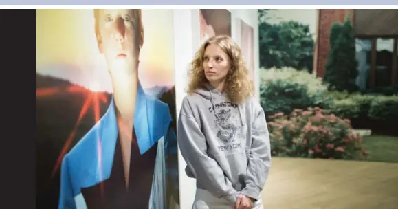  ?? NICK KOZAK PHOTOS/TORONTO STAR ?? Petra Collins looks into the eyes of her cousin, pictured in her photograph Little Prince (Palko), at the opening of her solo show Pacifier at the Contact Gallery.