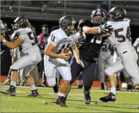  ?? BARRY TAGLIEBER - FOR DIGITAL FIRST MEDIA ?? Pottsgrove quarterbac­k Jay Sisko rolls out of the pocket Friday against Phoenixvil­le.