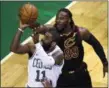  ?? CHARLES KRUPA — THE ASSOCIATED PRESS ?? Celtics guard Kyrie Irving drives to the basket past Cavaliers forward Jae Crowder during the first quarter.