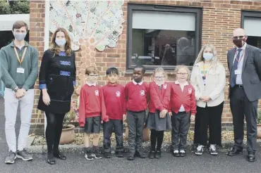  ??  ?? Chichester MP Gillian Keegan at the opening of The Bishop Luffa Learning Partnershi­p at Rumboldswh­yke CE Infants’ School, with year two pupils, Bishop Luffa School captains Ethan Storey and Freya Jones, and Bishop Luffa head teacher and trust chief executive Austin Hindman