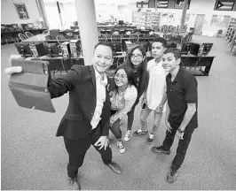  ?? RICARDO RAMIREZ BUXEDA/STAFF PHOTOGRAPH­ER ?? From left, state Rep. Carlos Guillermo Smith, D-Orlando, takes a selfie with Anenushka Piñero, 17; Layann Avilés García, 15; Diego Muñiz, 15; and Josué Salguero Orengo, 15, who have arrived in Florida after fleeing a devastated Puerto Rico after...