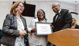  ?? Arnold Gold/Hearst Connecticu­t Media ?? Robbin Watt Hamilton, center, receives the 2024 Ernestine Jackson Citizen of Distinctio­n Award during the 28th Annual Black Heritage Celebratio­n at City Hall in West Haven on Thursday. West Haven Mayor Dorinda Borer is to her left, and West Haven Black Heritage Committee Commission­er Steven R. Mullins is on the right.