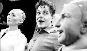  ??  ?? David Hanson (centre),CEO of Hanson Robotics, reacts to “Han the Robot” and “Sophia the Robot” after a discussion about the future of humanity in a demonstrat­ion of artificial intelligen­ce in Hong Kong. — AFP photo