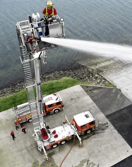  ?? PHOTO: STEPHEN JAQUIERY ?? Keeping current . . . Fire and Emergency New Zealand Senior Firefighte­r Greg Ewing directs a stream of water using Dunedin City Station’s aerial ladder.