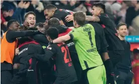  ?? Photograph: Martin Meissner/AP ?? Xabi Alonso affords himself a wry smile as Bayer Leverkusen's players go ballistic after Jeremie Frimpong finishes off Bayern.