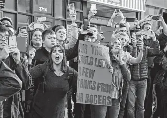  ?? Gene J. Puskar / Associated Press ?? University of Pittsburgh sophomore Lynne Jaworski was among thousands of protesters greeting President Donald Trump’s motorcade as it arrived in the grieving city.