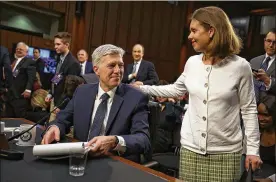  ?? JUSTIN SULLIVAN / GETTY IMAGES ?? Judge Neil Gorsuch talks with his wife, Marie Louise Gorsuch, at his confirmati­on hearing Wednesday before the Senate Judiciary Committee. He repeated his commitment­s to adhering faithfully to precedent, the law and independen­ce.