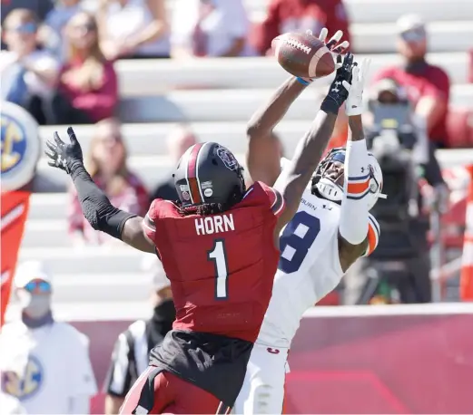  ?? GETTY IMAGES ?? South Carolina cornerback Jaycee Horn, breaking up a pass to Auburn’s Seth Williams, had two intercepti­ons in the Gamecocks’ upset of the No. 15 Tigers.