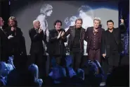  ?? MIKE COPPOLA — GETTY IMAGES ?? Steve Perry, far right, with other members of Journey accepts an award onstage at the 32nd Annual Rock and Roll Hall Of Fame Induction Ceremony at Barclays Center on April 7, 2017, in New York City.