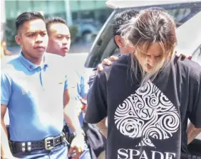  ?? ALDO NELBERT BANAYNAL ?? Cebuano rap singer Range 999 is arrested after he allegedly shot and injured an American national outside a bar in Cebu City on Sunday.
