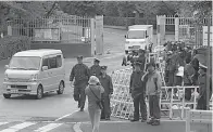  ?? AP Photo/Shuji Kajiyama ?? ■ Police officers stand guard Friday near the gate of Tokyo Detention Center where doomsday cult leader Shoko Asahara was executed.