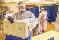  ?? MARK MIRKO/HARTFORD COURANT ?? A Griffin Health worker stores COVID-19 tests at Eastern Connecticu­t State University in January.