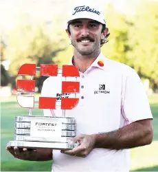  ?? — AFP photo ?? Homa celebrates with the champion’s trophy after winning the Fortinet Championsh­ip at Silverado Resort and Spa in Napa, California.