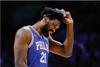  ?? MATT SLOCUM — THE ASSOCIATED PRESS ?? Sixers center Joel Embiid lifts up his mask during the first half of Game 3Friday night at Wells Fargo Center.