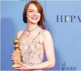  ??  ?? Emma Stone poses with her award for best actress in a musical or comedy for her role in ‘La La Land’.