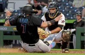  ?? Matt Freed/Post-Gazette ?? Pirates catcher Jacob Stallings tags out Marlins catcher Sandy Leon in the fourth inning Friday at PNC Park.