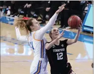  ??  ?? Stanford guard Lexie Hull (12) drives to the basket as UCLA forward Emily Bessoir defends during the first half Monday night in Los Angeles.