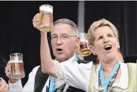  ?? WATERLOO REGION RECORD FILE PHOTO ?? Regional Chair Ken Seiling raises a mug of beer along with Premier Kathleen Wynne at the Oktoberfes­t keg tapping ceremony at Kitchener City Hall last October.