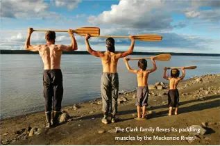  ??  ?? The Clark family flexes its paddling muscles by the Mackenzie River.
