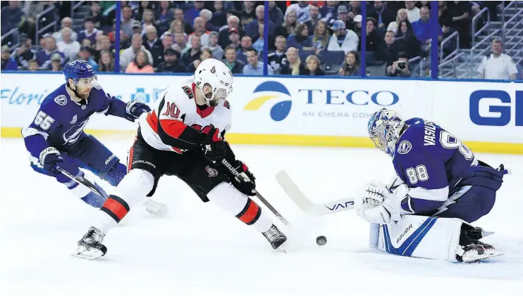  ?? — GETTY IMAGES ?? Andrei Vasilevski­y of the Lightning, right, stops a shot from Tom Pyatt of the Senators at Amalie Arena on Tuesday in Tampa, Fla. Ottawa won 7-4.