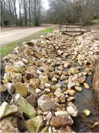  ?? (Photo by Neil Abeles) ?? ABOVE: The newly cleared and rock filled drainage ditch at Linden City Park trails off from the lower area of the park northward toward the Kaufman Street bridge and the courthouse square area. The rock has been placed by Franks Engineerin­g.