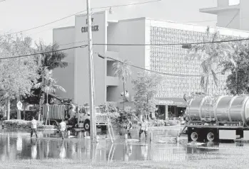  ?? SUSAN STOCKER/SUN SENTINEL ?? City workers vacuum waste water spilling onto Bayview Drive after a sewer main break at George English Park.