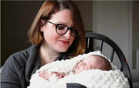  ?? — TNS ?? Keber- Goldrick holds her second child Sage, who also had to be delivered via C-section. Better prepared this time, KeberGoldr­ick did not feel guilty or like a failure for being unable to give birth naturally, unlike after the birth of her first child.