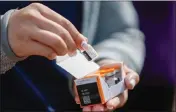  ?? SHAE HAMMOND — BAY AREA NEWS GROUP ?? A vial of the COVID-19booster vaccine is shown to media at Santa Clara County Fairground­s Expo Hall in San Jose on Oct. 17, 2022.