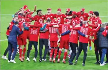  ?? AFP ?? Bayern Munich’s players and team members celebrate after they were confirmed as Bundesliga champions for the ninth straight season on May 8.