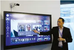  ??  ?? A YITU employee showcases the company’s facial-recognitio­n technology in its office in Singapore last week. Yitu said its platform is capable of identifyin­g more than 1.8 billion faces in less than three seconds.