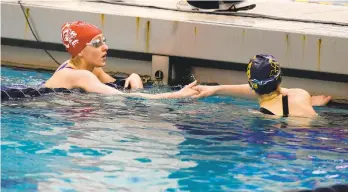  ?? MORNING CALL PHOTOS RICK KINTZEL/THE ?? Parkland’s Kayla Johnson, left, congratula­tes another swimmer after the 50-yard freestyle Wednesday during the PIAA Swimming and Diving Championsh­ips at Bucknell University in Lewisburg.