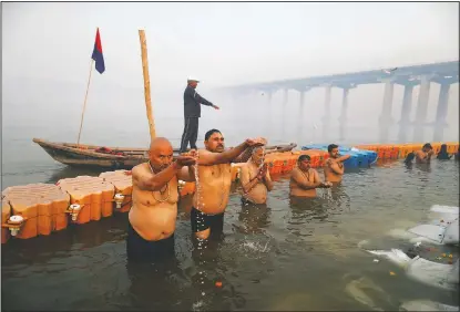  ??  ?? Devotees pray and take holy dips at Sangam.