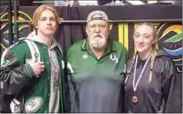  ?? PHOTO BY DESI LOVENGUTH ?? Levi Hart (ninth place) and Reese Hart (third place), both in this picture with Coach Desi Lovenguth, medaled at the Masters Tourney in Fresno and qualified to compete in their weight class in the upcoming CIF State Tournament.