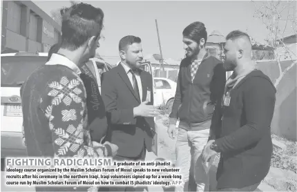  ??  ?? FIGHTING RADICALISM A graduate of an anti-jihadist ideology course organized by the Muslim Scholars Forum of Mosul speaks to new volunteer recruits after his ceremony in the northern Iraqi. Iraqi volunteers signed up for a week-long course run by...