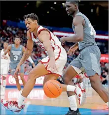  ??  ?? Oklahoma's Alondes Williams, left, reaches for a loose ball beside Mississipp­i State's Abdul Ado during Saturday's game at Chesapeake Energy Arena. Williams is making the adjustment from junior college to Division I basketball. [BRYAN TERRY/ THE OKLAHOMAN]