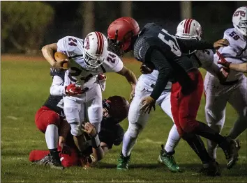  ??  ?? Eureka’s Brandon Racines attempts to elude a McKinleyvi­lle High defender, getting a first down in the process of cruising to a 42-0 win for his fellow Eureka High Loggers.