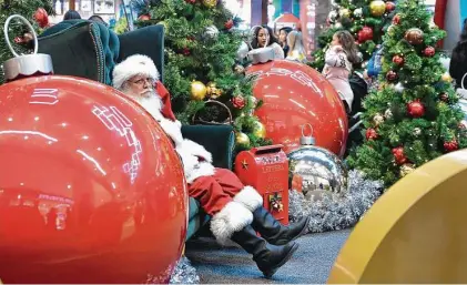  ?? Getty Images file photo ?? Retailers should be sporting a happier look than this Santa during the holiday shopping season. Consulting firm Deloitte says American families will spend an average of $1,536 this season, up from $1,226 last year.