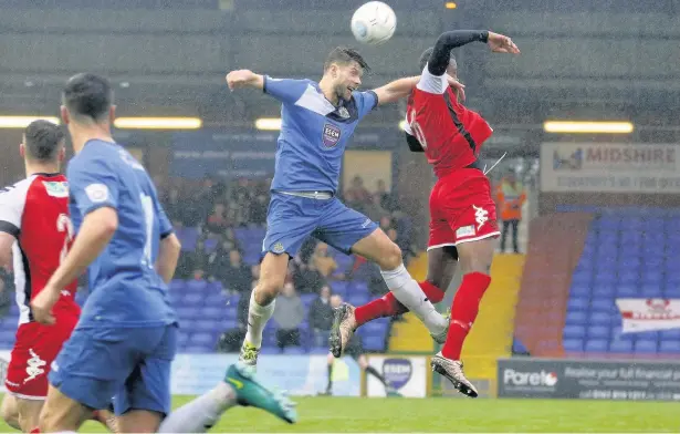  ?? Www.mphotograp­hic.co.uk ?? ●●Jason Oswell gets up to win an aerial challenge during County’s 2-1 defeat against Kiddermins­ter at Edgeley Park