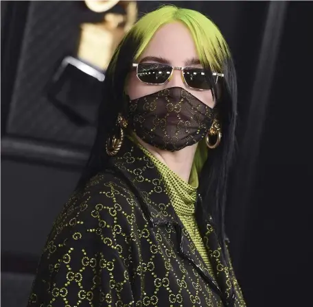  ?? JORDAN sTRAuss / Ap fiLE ?? TREND SETTER: Billie Eilish is ahead of the crowd wearing a face covering to the Grammys in January.