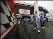  ?? WADE PAYNE — THE ASSOCIATED PRESS ?? People leave the track as rain falls before a NASCAR Monster Energy NASCAR Cup Series auto race.