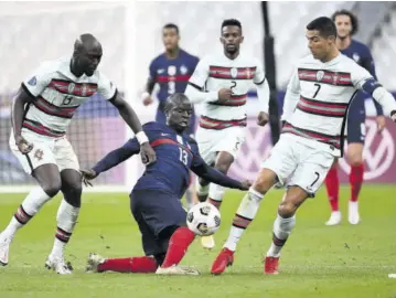  ??  ?? France’s midfielder N’golo Kante (centre) vies with Portugal’s forward Ronaldo (right) during the Nations League football match between France and Portugal yesterday at Stade de France in Saint-denis, outside Paris.