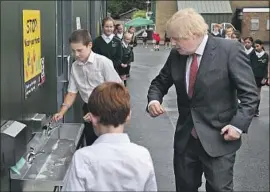  ?? Steve Parsons AFP/Getty Images ?? PRIME MINISTER Boris Johnson washes his hands at Bovingdon Primary Academy on Friday in Britain, where progress was reported against COVID-19.