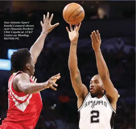  ??  ?? San Antonio Spurs’ Kawhi Leonard shoots over Houston Rockets’ Clint Capela at AT&T Centre on Monday.