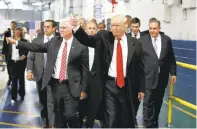  ??  ?? Trump and Pence wave to workers at the Carrier factory.