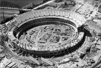  ?? A. Church Photograph­ers ?? Workers build and construct the upper bowl of the gigantic cement structure on Aug. 20, 1969 — the type of cookie-cutter stadium that became popular in the 1970s.