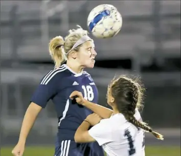  ?? Matt Freed/Post-Gazette photos ?? Freeport's Hannah Stokes heads the ball against Burrell's Allison Vescio Wednesday night.