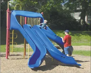  ?? H John Voorhees III / Hearst Connecticu­t Media ?? Ryan Kozlowski, 2, uses the slide in Parloa Park while his father Michael Kozlowski watches in Bethel on Thursday.