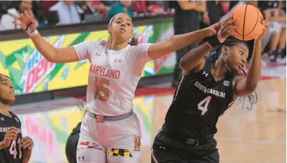  ?? KARL MERTON FERRON/BALTIMORE SUN ?? South Carolina forward Aliyah Boston (4) hauls in a rebound in front of Maryland guard/forward Mila Reynolds (15) as guard Kierra Fletcher (41) watches during the third quarter Friday night.