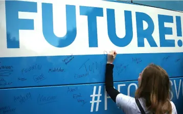  ??  ?? Members of Our Future, Our Choice (OFOC) a youth movement supporting a People’s vote on the Brexit deal sign a bus used by the organisati­on to promote their cause in London. — AFP photo